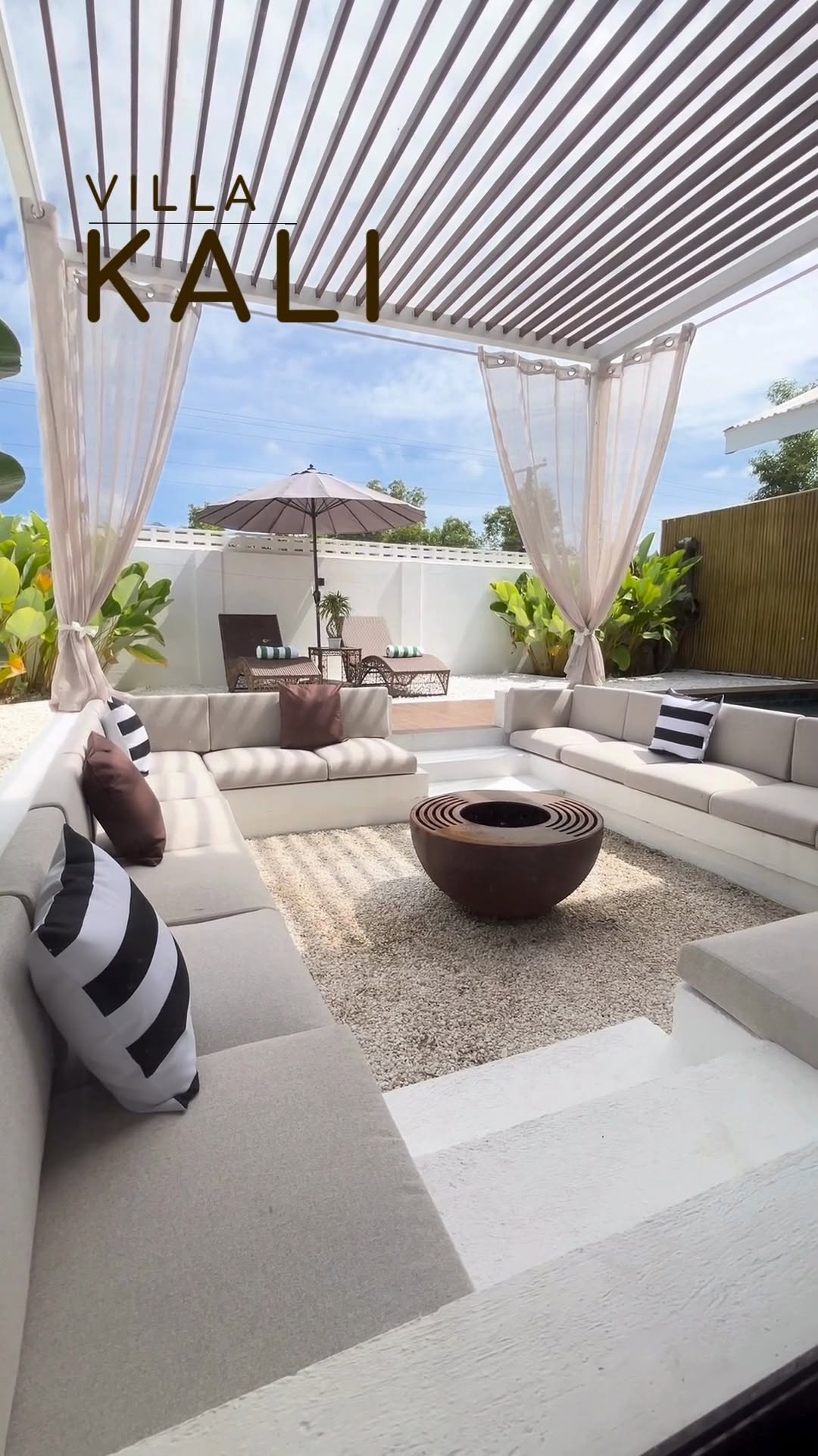 Villa Kali — sunken lounge with white sectional sofa and retractable pergola beside the pool